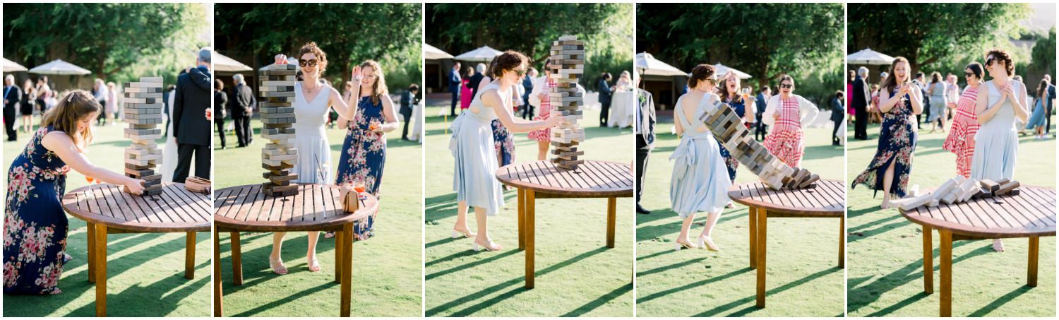 wedding guests playing large jenga and it falling